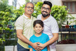 © GAJENDRRA BHATI  - Happy indian senior father standing with his son and grandson smiling looking at camera.