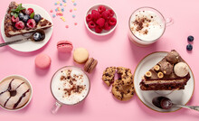 Table With Various Cookies, Donuts, Cakes, Coffee Cups On Pink Background.