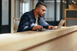 © Jacob Lund - Web design professional working on a laptop in a coworking office