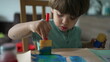 © Marco - One little boy using coloring brush to paint at home. Child creativity artistic activity at home. Kid coloring