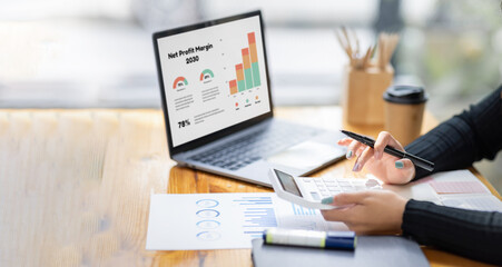 Close up of businesswoman Accounting using calculating income-expenditure and analyzing real estate investment data report Financial and tax systems concept.	