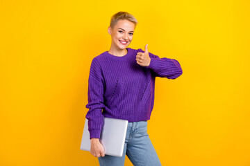 Photo of charming positive lady user modern gadget wear stylish knitted pullover thumb up nice shopping isolated on yellow color background