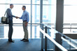 © Reese/peopleimages.com - Business men, handshake and partnership deal in hotel lobby, modern office or airport lounge in CRM team meeting. Corporate people, employees and shaking hands in collaboration, agreement or success