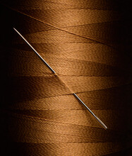 Close Up Of Needle In Gold Thread