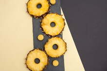 Raw Pineapple Slices Are Placed On A Black Background With Yellow
