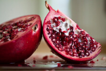A Juicy Sliced Organic Pomegranate Sits On A Counter Top In Seattle, Washington.