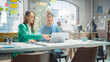 © Gorodenkoff - Portrait of Two Creative Colleagues Collaborating and Pointing at the Laptop Screen in Office Hub. White Female Designer Discussing Work with Assistant and Choosing Marketing Strategy