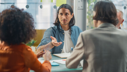 Aufkleber - Meeting at Office Concept: Young Latin Man Pitching his Development Idea to a Group of Multiethnic Colleagues. New Employee Showing Initiative and Creativity, Sharing Innovative Solutions