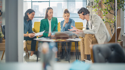 Poster - Diverse Group of People Talking in a Casual Modern Meeting Room in Office Using Laptop Computer. Group of Colleagues From Different Ethnicities Collaborating, Working as a Team on Crisis Management.