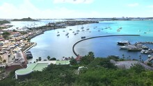 High Point Looking Down On Bay Of Marigot, St. Martin With The City Waterfront And Sailboats And Luxury Watercraft Anchored In The Harbor