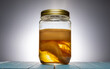 Kombucha scoby in a jar. Scoby is an abbreviation for “Symbiotic Colony of Bacteria and Yeast” (also called as kombucha mother). Kombucha tea is a source of probiotics and contains antioxidants.