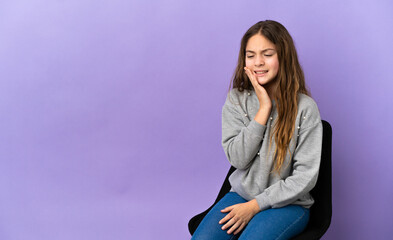 Wall Mural - Little caucasian girl sitting on a chair isolated on purple background with toothache