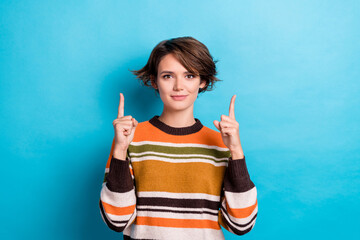 Wall Mural - Portrait of nice pretty positive woman with short hairdo wear orange sweater directing empty space isolated on blue color background