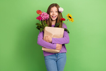 Poster - Photo of adorable positive lady wear stylish clothes receive gift nice different flowers isolated on green color background