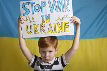 Wall Mural - Boy holding poster Stop War in Ukraine against national flag