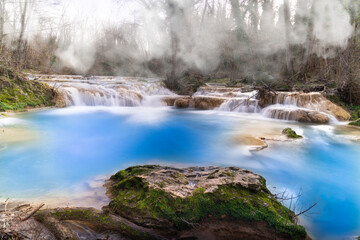 Wall Mural - wide view of multiple waterfalls produced by the elsa river in tuscany