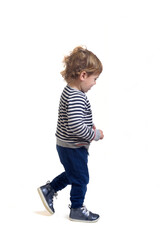 side view of a baby boy walking on white background