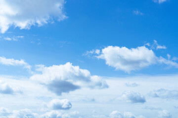 Wall Mural - blue sky with white fluffy clouds textured background.