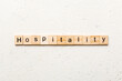© sosiukin - hospitality word written on wood block. hospitality text on table, concept