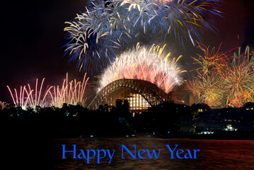 Wall Mural - Sydney Harbour Bridge New Years Eve fireworks, colourful NYE fire works lighting the night skies with vivid multi colours NSW Australia. written words Happy New Year