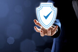 Fototapeta  - Anti-fraud security system. Man with illustration of checkmark in shield on dark background, closeup. Space for text