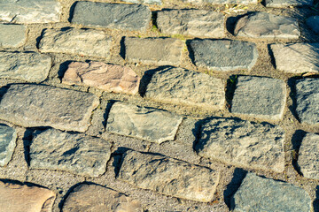 Cobblestone or brick facade on pathway for travel or transportation with multicolor stones on exterior