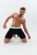 © SHOTPRIME STUDIO - Man athletic body bodybuilder in briefs with naked torso abs full-length in the background, fitness classes. Advertising, sports, active lifestyle, competition, challenge concept.