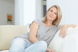 © Reese/peopleimages.com - Relax, portrait and woman on a sofa in the living room for rest, relaxing and chilling at home. Comfort, calm and mature female with positive mindset from Australia sitting on the couch in her house.