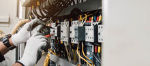 Electrician Engineer Tests Electrical Installations And Wires On Relay Protection System.