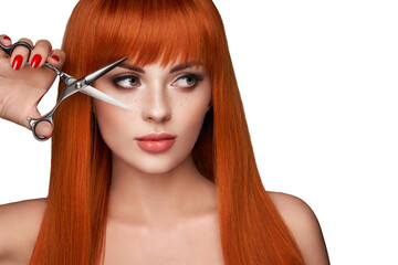 Wall Mural - beautiful young woman with a bright makeup and a smooth long hair holds metal scissors. model with r