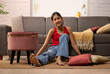 © IndiaPix - Portrait of a girl looking at camera while sitting on floor in living room