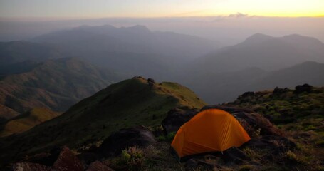 camping in the mountains with tent on high hill.