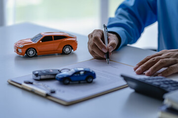 A car dealer or sales manager offers to sell a car and explains the terms of signing a car and insurance contract.