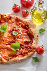 Wall Mural - Delicious pizza Margherita served with olive oil and basil.