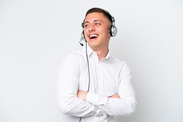 Wall Mural - Telemarketer Brazilian man working with a headset isolated on white background happy and smiling