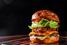  barbecue pulled beef burger with vegetables on dark background