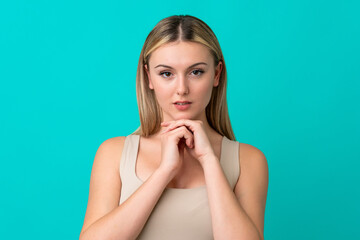 Wall Mural - Portrait of pretty young woman over blue isolated background