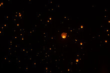 Low Angle View Of Illuminated Lanterns Flying Against Sky During Chinese New Year At Night
