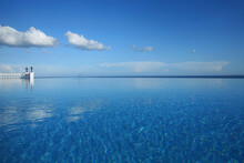 Enormous Infinity Pool Beneath A Blue Sky At A Hotel Resort In The Philippines.