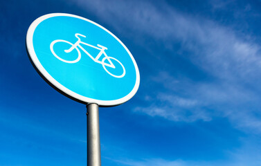 Bicycle sign in the city on the background of blue sky close up