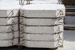 Reinforced concrete slabs for strengthening riverbeds and highway ditches, a stack of slabs in a warehouse of a manufacturing enterprise, close-up.