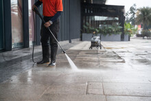 Cleaning Staff Hoses A Portable Car For Washing The Concrete Floor With High-pressure Water Jets.