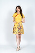 © Said - A beautiful asian woman doing a pose while wearing simple yellow chinese dress