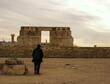 guy walking towords ruins in cotidal Amman Jordan