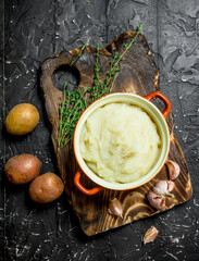 Sticker - Mashed potatoes in a bowl with garlic and thyme.