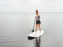 Teenage Girl On A Stand Up Paddle Board