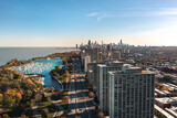 Fototapeta Tęcza - Beautiful aerial cityscape view of downtown Chicago above Lake Shore Drive with Belmont Harbor and residential highrise buildings in the Lakeview neighborhood in the foreground on a sunny fall day.