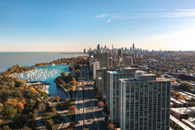 Beautiful Aerial Cityscape View Of Downtown Chicago Above Lake Shore Drive With Belmont Harbor And Residential Highrise Buildings In The Lakeview Neighborhood In The Foreground On A Sunny Fall Day.