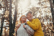 © Daniel - Head shot portrait close up of middle age cheerful people smiling and looking at the the trees of the forest around them. Active couple of old seniors hiking and walking together in the mountain