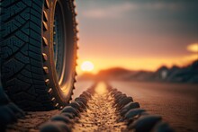  A Tire On A Road With The Sun Setting In The Background And A Line Of Rocks On The Side Of The Road That Is Lined With A Tire And A Line Of The Road,. Generative Ai